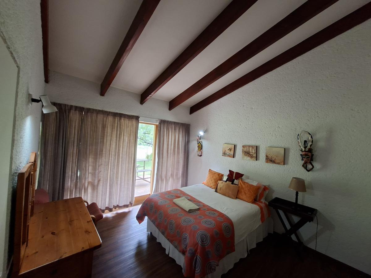 Nokeng room with double bed and African art